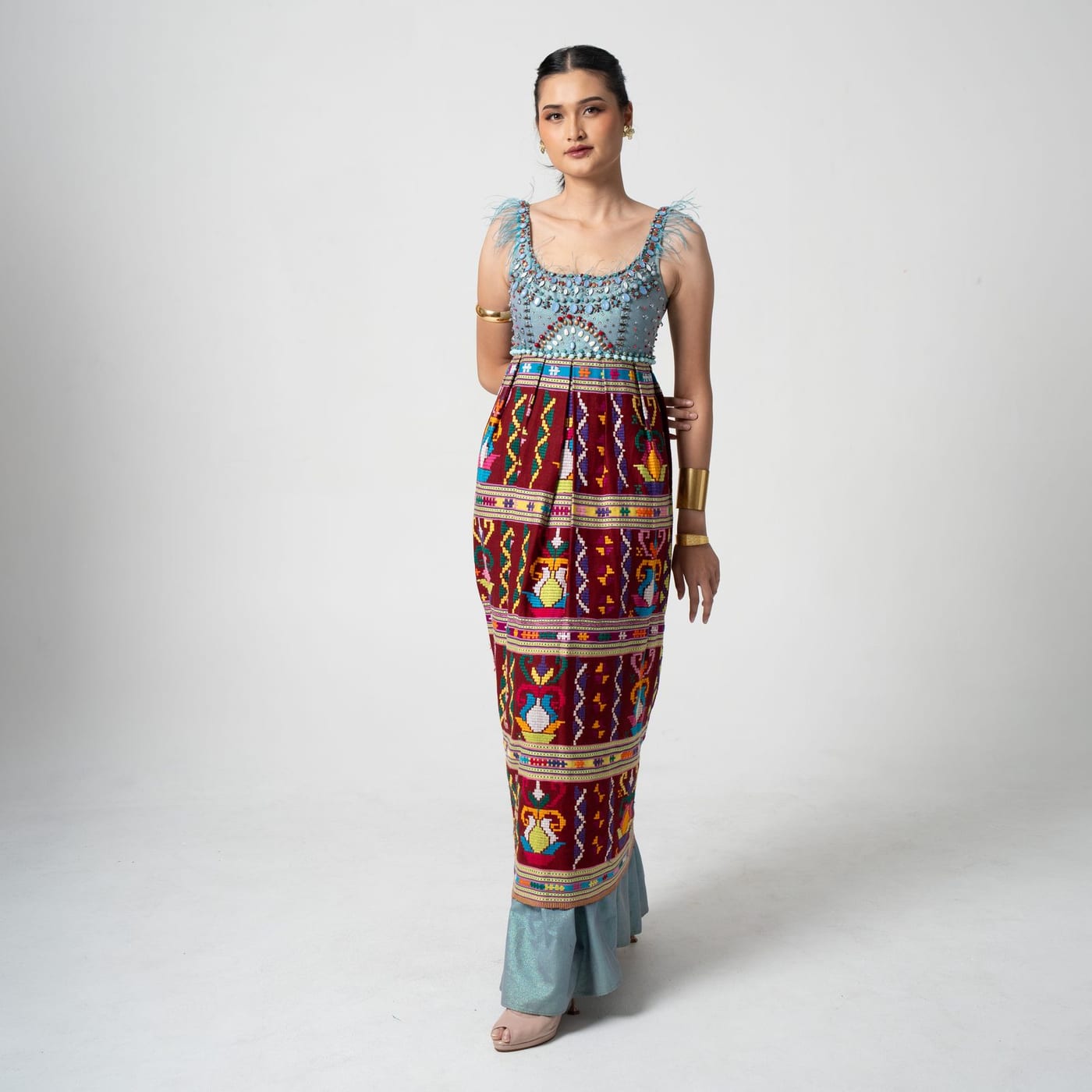 Songket Ikat, handwoven songket geometry with a beaded, feather-trimmed bodice